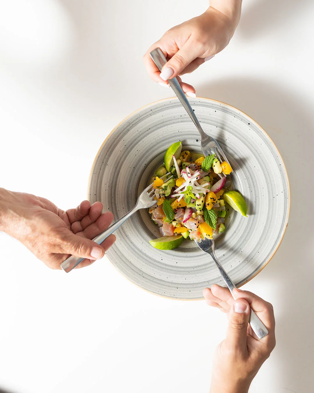 Friends sharing a plate at Scirocco